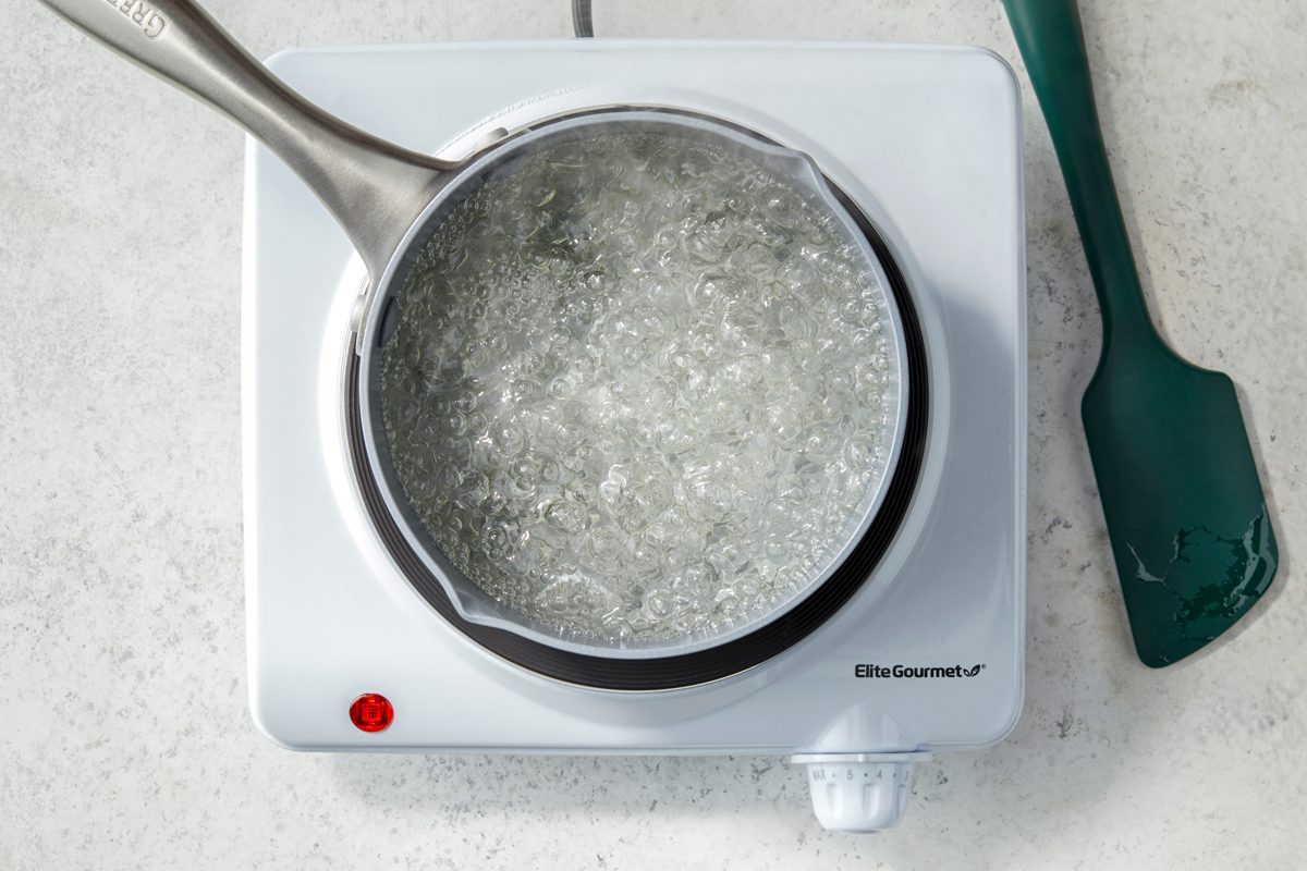 Overhead shot of the same saucepan; induction; bring to a boil over medium heat; spatula; marble surface