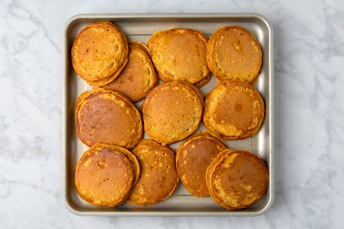 Overheda shot of Fluffy Sweet Potato Pancakes; in a baking pan; marble surface;