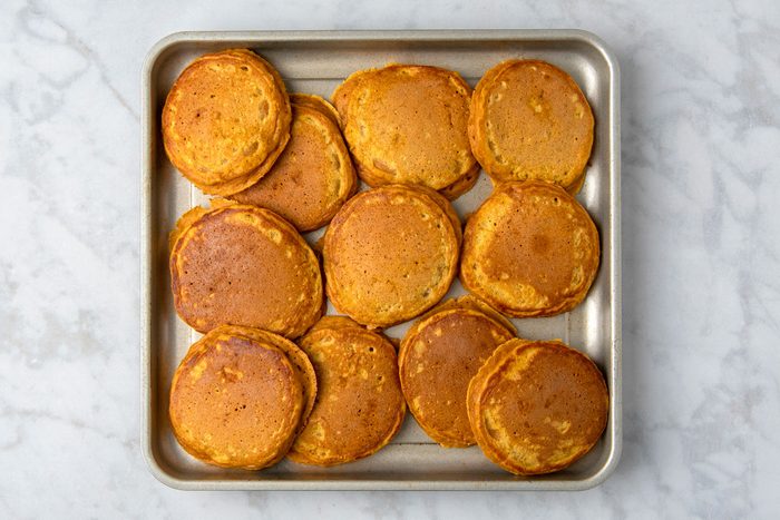 Overheda shot of Fluffy Sweet Potato Pancakes; in a baking pan; marble surface;