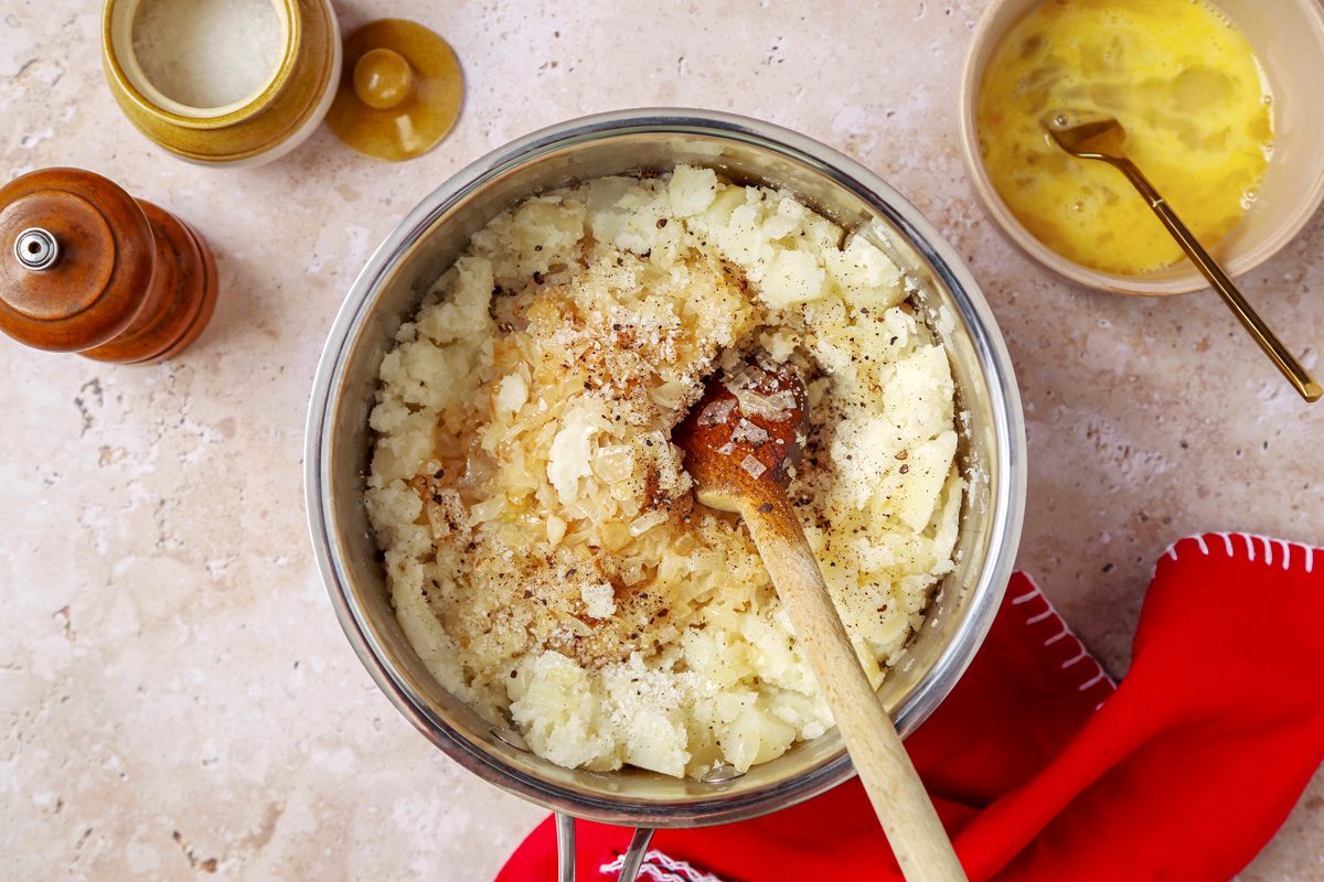 Mashed potatoes mixed with onion mixture, salt and pepper and an egg