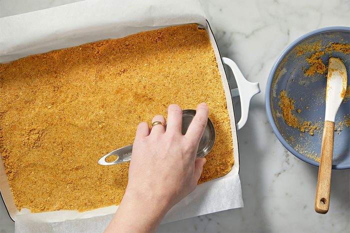 Preparing gram cracker crust for Strawberry Cheesecake Bars