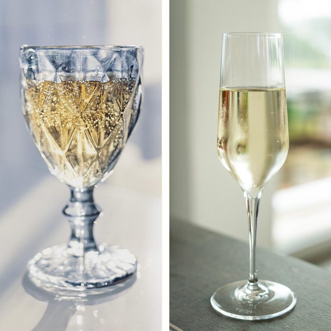 Crystal champagne glass on the left, compared with a glass champagne flute on the right, both containing champagne